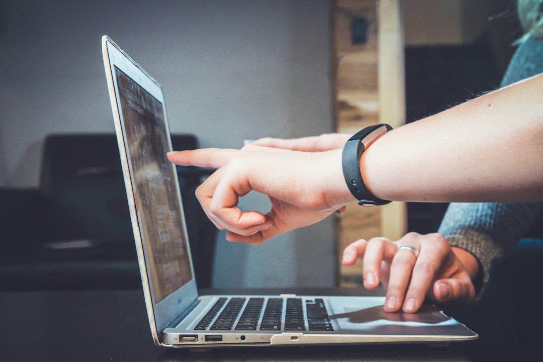 People considering a digital product on a laptop